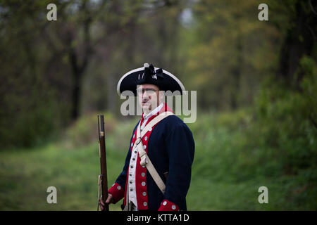 Clay Frankhead, a reenactor portraying a Continental Soldier with the First New Jersey Regiment, fires his musket  to mark the beginning of a twelve-mile timed ruck march during the Region One Best Warrior Competition on 26 April, 2017.  Fourteen Soldiers are competing in the three-day event, April 25-27, 2017, which features timed events, including urban warfare simulations, a 12-mile ruck march, land navigation, and the Army Physical Fitness Test. The two winners will go on to compete in the 2017 Army National Guard Best Warrior Competition to be named the Army Guard's best-of-the-best and e Stock Photo