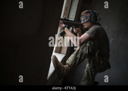 Members of the New Jersey Army National Guard portray enemy forces (also known as OpFor) during a movement to contact exercise at Fort Dix, New Jersey on 26 April 2017 during the Region One Best Warrior Competition. Soldiers taking part in the exercise moved from building to building, clearing rooms and retrieving the rescue dummy before being retrieved by friendly forces.  Fourteen Soldiers are competing in the three-day event, April 25-27, 2017, which features timed events, including urban warfare simulations, a 12-mile ruck march, land navigation, and the Army Physical Fitness Test. The two Stock Photo