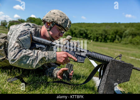 U.S. Army Spc. Bryant Pinette, with Delta Company, 2nd Battalion, 108th Infantry Regiment, New York Army National Guard, loads his M4 carbine during the SGT Henry Johnson Individual Combat Rifle Match as part of the 38th Annual &quot;TAG (The Adjutant General) Match&quot; Combat Sustainment Training Exercise at Camp Smith Training Site, N.Y., June 3, 2017. The TAG Match is a 3-day event conducted by the New York Army National Guard to promote excellence in marksmanship training and offer Soldiers, Airmen and State Militia the opportunity to test their skills and weapon systems in a battle-focu Stock Photo