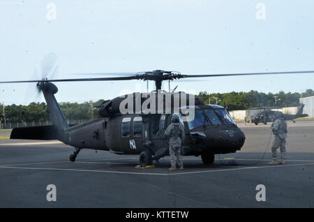 Ronkonkoma, NY - Aircrews of the New York Army National Guard’s Company B, 3rd Battalion, 142nd Aviation Regiment prepare for takeoff and deployment from Long Island MacArthur Airport, Islip, N.Y. to Florida in support of the Guard response to Hurricane Irma September 11, 2017.    Ten UH-60 Blackhawk helicopters and 55 aircrew members and maintainers deployed from three flight facilities across the state to support the Florida Army National Guard. U.S. National Guard photo by Capt. Mark Getman, New York Guard. Stock Photo