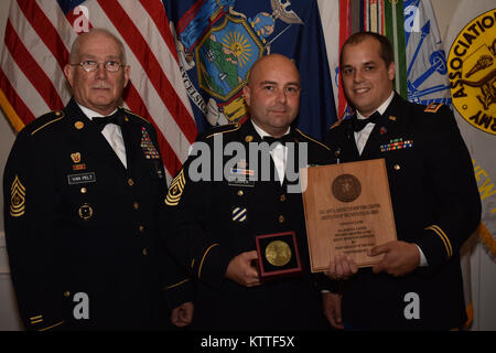 N.Y. Army National Guard Soldier First Sgt. Joseph Cooper receives the First Sgt. of the Year and Recruiter of the Year award, at the Association of the United States Army’s(AUSA) Soldier Recognition dinner, in Albany, N.Y., Sept. 23, 2017. Soldiers from the Albany Recruiting Battalion received awards for their own contributions to the N.Y. Army National Guard. (N.Y. Army National Guard photo by Pfc. Andrew Valenza) Stock Photo