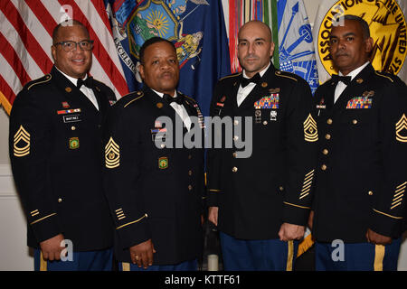 Soldiers from the 258 Field Artillery stand together at the Association of the United States Army(AUSA) through their company AEON Nexus, during the AUSA Soldier Recognition dinner, in Albany, N.Y., Sept. 23, 2017. The AUSA was recognizing Soldiers and Civilians who had done incredible service towards the United States Army. (N.Y. National Guard photo by Pfc. Andrew Valenza) Stock Photo