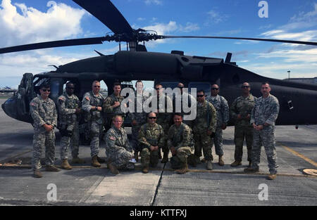 Soldiers of the New Yorik Army National Guard's 3rd Battalion 142nd Aviation stand in front of a UH-60 Blackhawk helicopter withy members of the New York National Guard's 442nd Military Police Company before heading out on a mission in Puerto Rico as part of the Hurricane Maria response. The battalion has deployed four UH-60 Blackhawk helicopters and 60 Soldiers to assist in recovery operations in the wake of Hurricane Maria. Stock Photo
