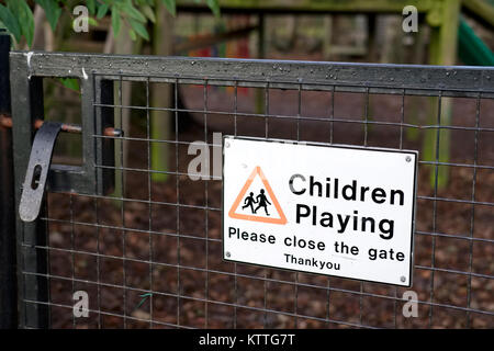 Children Playing Please Close Gate Sign at Kids Play Park Outdoors Stock Photo