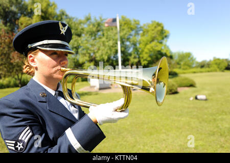 U.S. Air Force Senior Airman Cherice Baldwin practices the bugle at Hancock Field in Syracuse NY, on 22 July 2011.  Senior Airman Baldwin is a member of the 174th Fighter Wings’ honor guard. The 174th's honor guard participates in over three hundred ceremonies throughout New York in a year. (U.S. Air Force photo by Staff Sgt. Ricky Best) Stock Photo