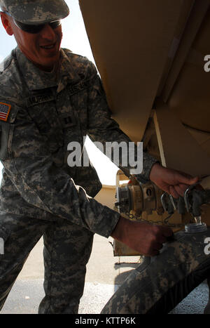 FORT IRWIN, Calif. – A Soldier from the New York Army National Guard’s 27th Infantry Brigade Combat Team refills his camelback while preparing for the brigade’s upcoming National Training Center rotation here Oct. 3.  The exercise will include more than 2,000 Soldiers from the brigade, along with a battalion from the South Carolina Army National Guard, with a realistic, demanding training environment.  U.S. Army photo by Sgt. 1st Class Raymond Drumsta, 27th Infantry Brigade Combat Team. (RELEASED) Stock Photo