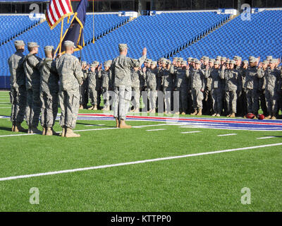 ORCHARD PARK, Buffalo-- One hundred New York Army National Guardsmen reaffirm their oath of service and later participated in a flag unfurling at the start of a Buffalo Bills National Football League game here Nov. 6 at Ralph Wilson Stadium, where the Bills hosted the New York Jets. Soldiers with the 42nd Infantry Division, 53rd Troop Command and 204th Engineer Battalion Forward Support Co. took part in the ceremony, which was taped and played during the games half-time in front of a sold-out crowd of 70,000 spectators. The Jets went on to defeat the Bills 27-11. Photo by Spc. Jimmy Bedgood, 4 Stock Photo