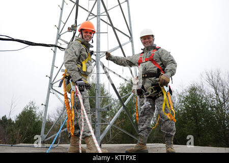 U.S. Air Force Chief Master Sgt Russell Youngs, the 174th FW Command Chief, and Tech. Sgt. Michael Griepsma prepare to climb an 85 ft. communications tower at Adirondack Range, Ft. Drum NY on 22 Nov 2011.  The towers are used to hold cameras to view targets down range.  (U.S. Air Force photo by TSgt Ricky Best) Stock Photo