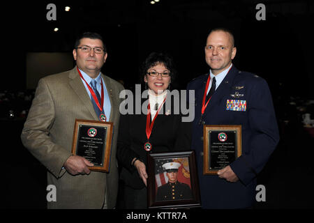 &quot;Fallen Marine inspires real heroes&quot;  U.S. Air Force Col. Tim Lunderman, Commander of the 222nd Command and Control Squadron, displays his newly received &quot; Real Heroes&quot; award presented by the Central New York chapter of The American Red Cross.  Lunderman is joined by fellow recipients Rick and Lorie Schneider.  The three received the award, Dec. 7, 2011 at the OnCenter in Syracuse NY during the annual Real Heroes Breakfast  put on by the American Red Cross. The event honors community members who have gone above and beyond to save the life of someone else. On July 10th, 2011 Stock Photo