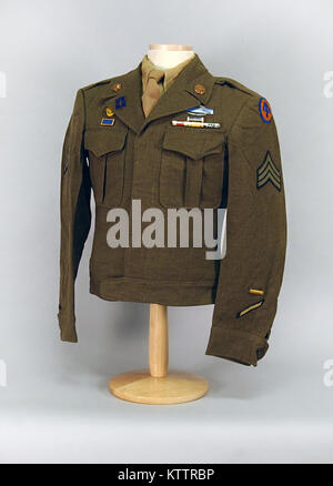 This is an “Ike Jacket” which was worn by Sgt. Ernest A. Bruderhausen, a New York City resident, during World War II. Bruderhausen was assigned to the 71st Infantry Regiment, a New York National Guard unit which served in Europe with the 44th Infantry Division. He was a German-born American who served as a translator.   The “Ike jacket” was worn by American Soldiers assigned to Europe during World War II as a dress uniform item and was later worn throughout the Army until after the Korean War. It got its name because General Eisenhower, the commander of all Allied Forces in Europe, liked it an Stock Photo