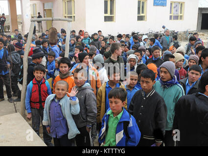 Young Afghan boys stand outside of the Aliabad School near Mazar-e-Sharif, Afghanistan, March 10, 2012. Their new school, a project started by the 1st Brigade, 10th Mountain Division, and continued by the 170th and 37th Infantry Brigade Combat Teams, is being built next to the current school and will accommodate the current volume of students with additional room for the town's growing population. (37th IBCT photo by Sgt. Kimberly Lamb) (Released) Stock Photo