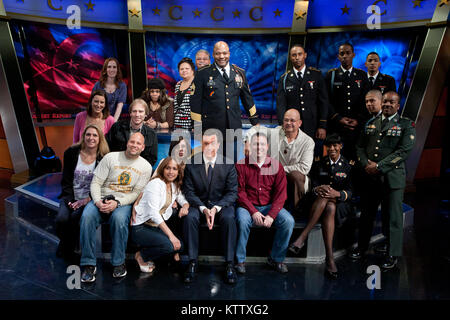 Soldiers and Family members of the 727th Military Police Law and Order Detachment, the 369th Sustainment Brigade and 1st Battalion, 69th Infantry Regiment gather around Stephen Colbert, host of The Colbert Report after his conversation with first lady Michelle Obama, on the first anniversary promoting Joining Forces,  a national initiative led by the first lady and Dr. Jill Biden that mobilizes all sectors of society to give our service members and their families the opportunities and support they have earned. Stock Photo