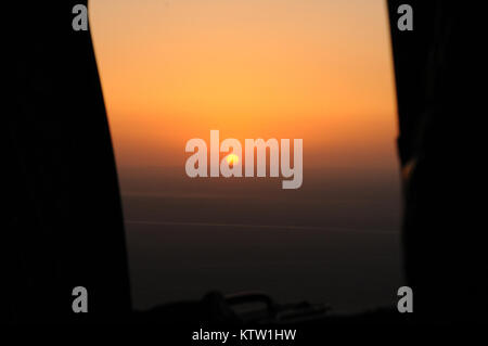 The view from the gunner's window on a Chinook helicopter as the sun sets near Kunduz, Kunduz Province, Afghanistan, June 3, 2012. (37th IBCT photo by Sgt. Kimberly Lamb) (Released) Stock Photo