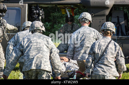 MARCY, NY --Soldiers of the 401st Civil Affairs Battalion, US Army Reserve, prepare one of their own to be loaded onto a Blackhawk from Company F, 1-169th General Support Aviation Battalion of the New York Army National Guard during medical evacuation training here on Thursday, July 12.   Photo by SPC Harley Jelis, HHC 42nd CAB, NYARNG Stock Photo