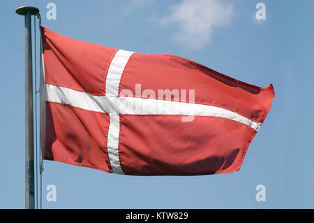 the flag of Denmark against blue sky Stock Photo