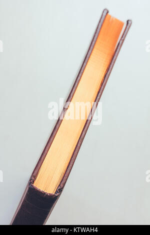 Top end view of page edges of closed hardcover book with roughly ...