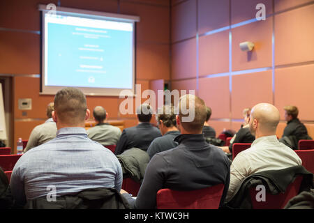 Audience in conference hall listening to presentation on business conference. Stock Photo