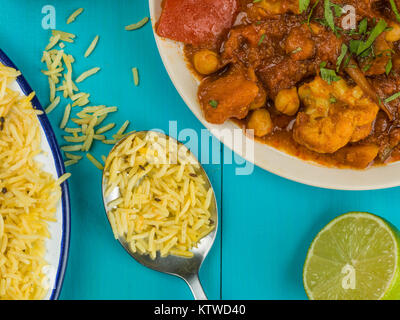 Mixed Indian Vegetable Masala Curry Against a Blue Background Stock Photo