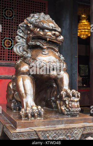 Lion bronze statue in front of a buddhist temple Stock Photo