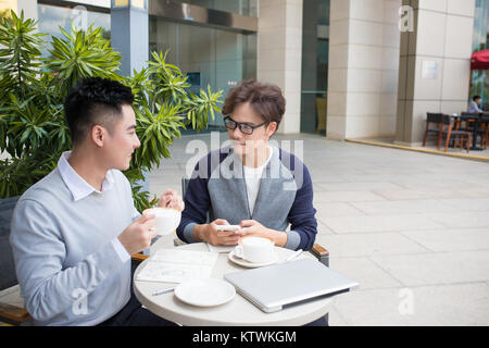 Two businessman having a casual meeting or discussion in the city. Stock Photo