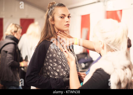 Female model wearing the Adidas Orginals SS13 Blue Collection at Copenhagen Fashion Week 2013 and getting ready for the show. Stock Photo