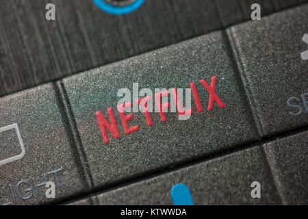 Netflix button on a Remote Control. Netflix Inc. is an American company founded specializes in and provides streaming media and video on demand online Stock Photo