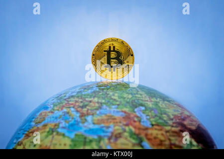 Bitcoin gold coin. Virtual cryptocurrency concept. Bitcoin as a symbol world currency. The cryptocurrency bitcoin on the globe. globalization, globali Stock Photo
