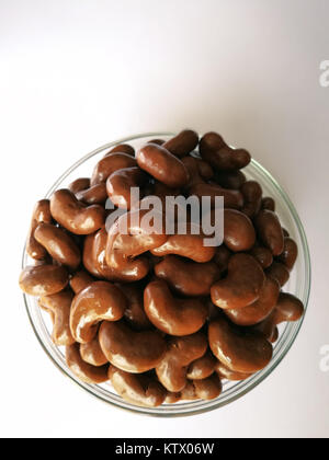 Chocolate covered biscuit in bean shaped on wooden background. Stock Photo