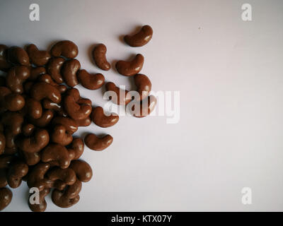 Chocolate covered biscuit in bean shaped on wooden background. Stock Photo