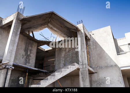 Abstract modern architecture under construction. Gray concrete floors, stairway and walls Stock Photo