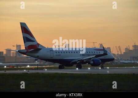 British Airways BA CityFlyer Embraer at London City Airport at dusk Stock Photo