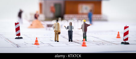 real estate development - construction manager with customers at building site Stock Photo