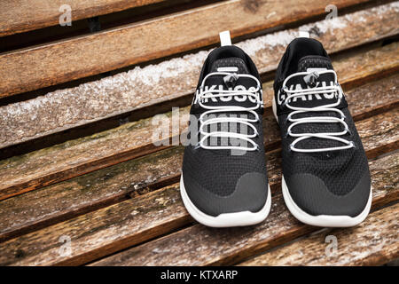 A pair of Black Gyakusou trainers on a bench Stock Photo