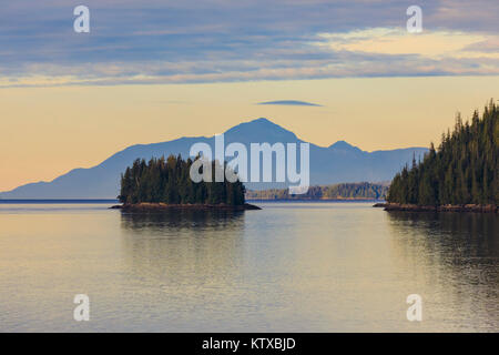 Sunrise, entering the Misty Fjords National Monument, islands, forest and distant mountains, Ketchikan, Southeast Alaska, United States of America, No Stock Photo