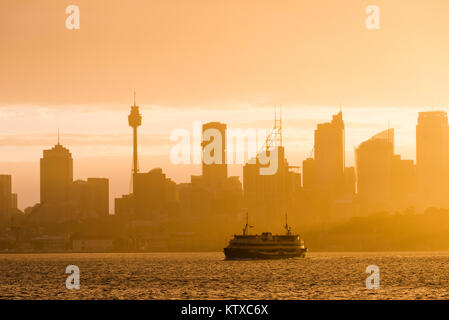 Sydney city skyline looking towards the sun with ferry, Sydney, New South Wales, Australia, Pacific Stock Photo