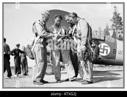 Finnish Airforce pilots during Winter War with American Brewster F2A Fighter planes behind with Swastika emblem on fuselage. Stock Photo