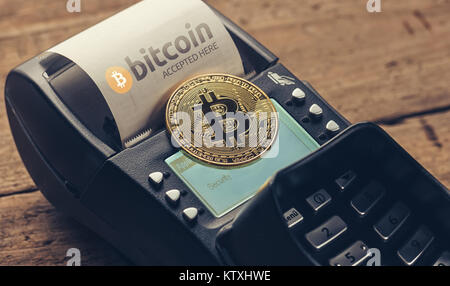 Customer pays by bitcoin to pay a bill at the cafe (bitcoin accepted here) Stock Photo