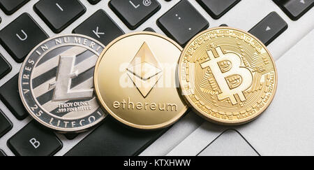Digital cryptocurrencys Bitcoin, Ethereum, Litecoin on a notebook Stock Photo