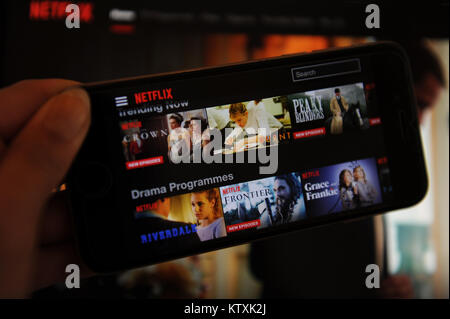The Netflix website on a phone and computer screen Stock Photo