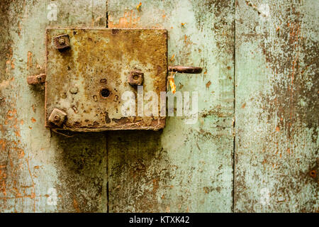 Old Door and rusty door lock in Green and Brown Stock Photo
