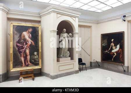 Paintings 'Saint John the Baptist' by Spanish painter Alonso Cano (L) and 'Saint Jerome Penitent' by Spanish painter Juespe de Ribera (R) and the statue of Saint Bruno of Cologne by Spanish sculptor Manuel Pereira on display in the Real Academia de Bellas Artes de San Fernando (Royal Academy of Fine Arts of San Fernando) in Madrid, Spain. Stock Photo