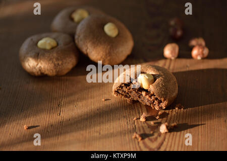 Artistic food still life of healthy sugar-free home-made Hazelnut butter cookies on brown rustic wooden table background Stock Photo