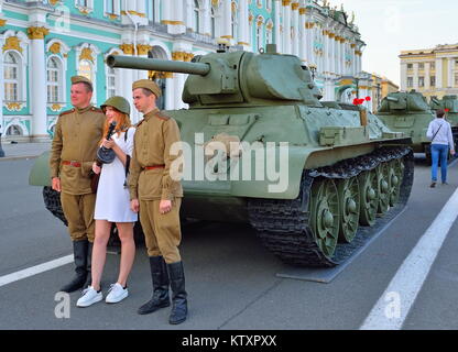 Girl in a white dress and a soldier's helmet is photographed wit Stock Photo
