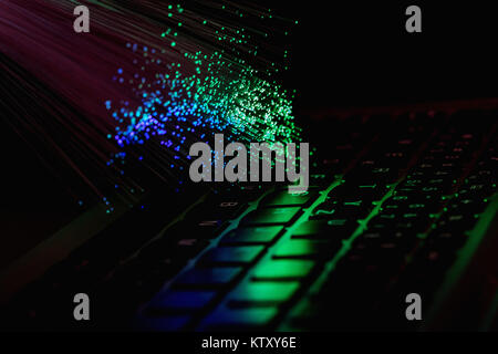 color fiber optical background with notebookk, Fiber optics lights abstract background Stock Photo