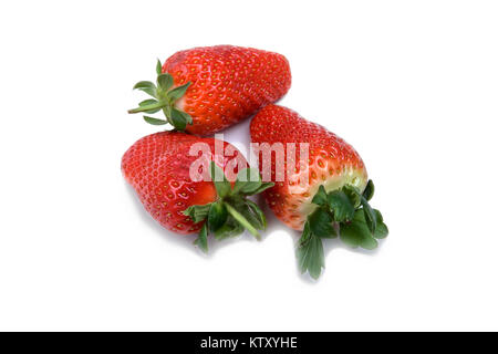 Three ripe strawberries with leaves on a white background Stock Photo ...