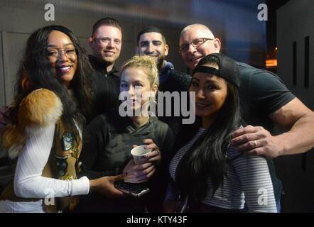 World Wrestling Entertainment (WWE) wrestlers (back, L-R) Alicia Fox, The Miz (Michael Mizanin), U.S. Army Medal of Honor Recipient Florent Groberg, professional chef Robert Irvine, (front, L-R) comedian Iliza Shlesinger, and professional wrestler Gail Kim pose for a group photo backstage during the USO Holiday Tour at the Al Dhafra Air Base December 22, 2017 in Abu Dhabi, United Arab Emirates. Stock Photo