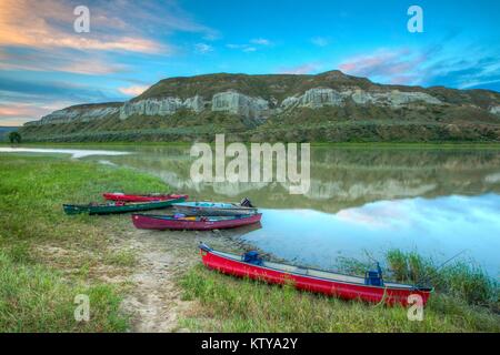 Canoes sit on the shore by the Upper Missouri Wild and Scenic River in the Upper Missouri River Breaks National Monument June 28, 2017 near Lewistown, Montana. Stock Photo