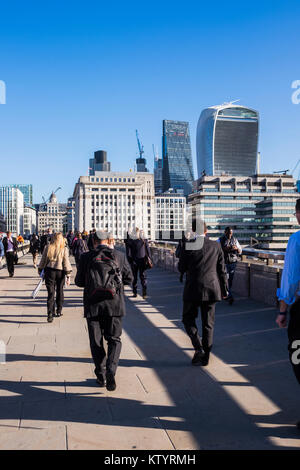 Commuters crossing London Bridge to work in the City of London, England, U.K. Stock Photo