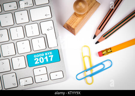 good bye 2017, Business concept. Computer keyboard on a white office desk with various items