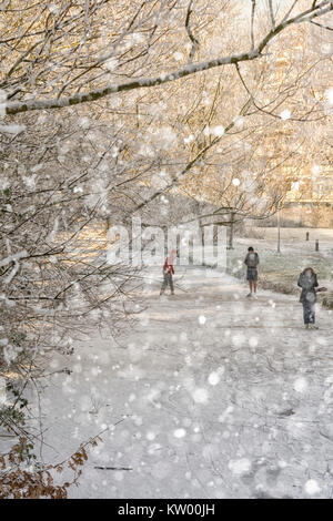 girls and boys on ice skates on a frozen canal in winter time with sunshine Stock Photo